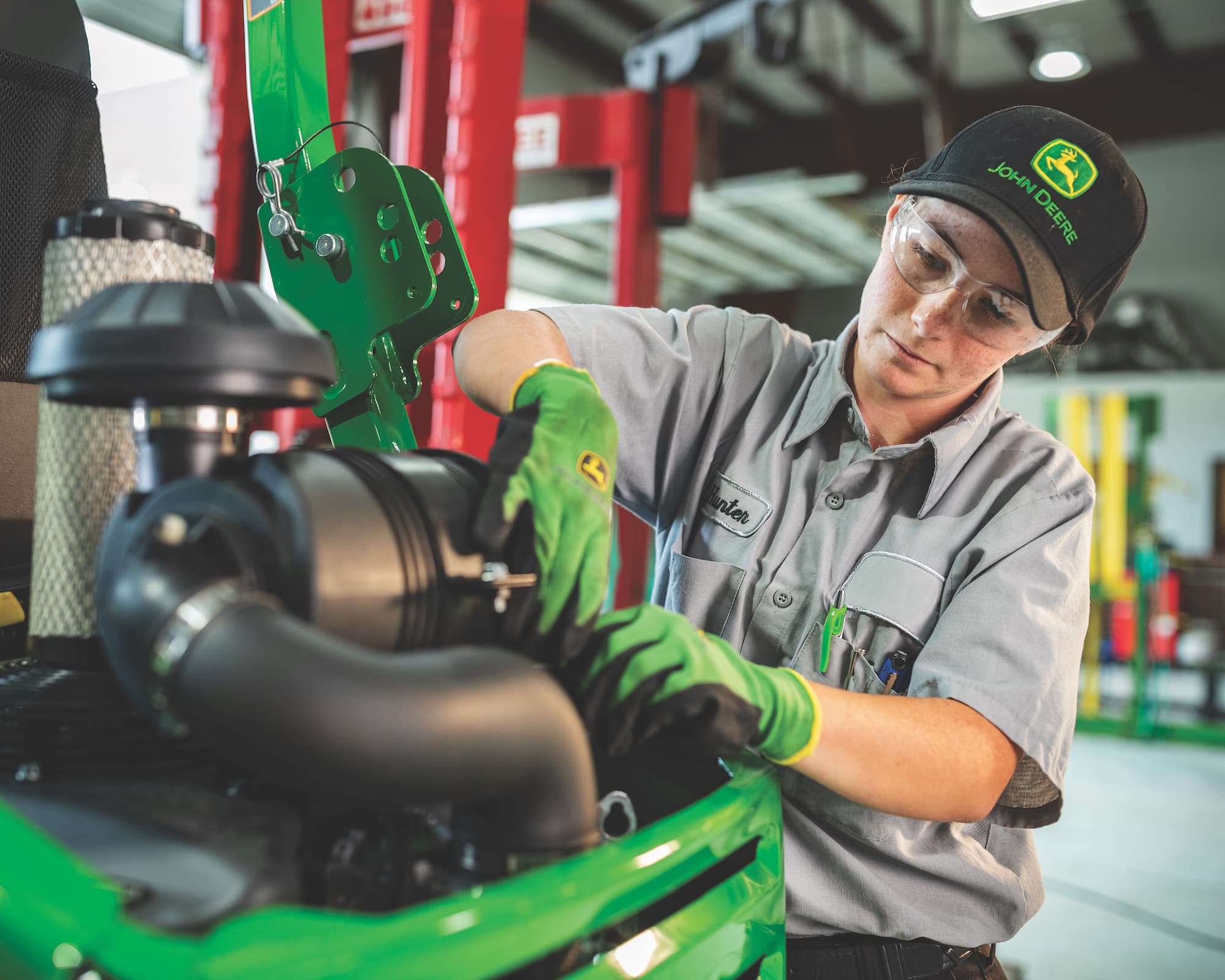 Service technician working on a John Deere tractor